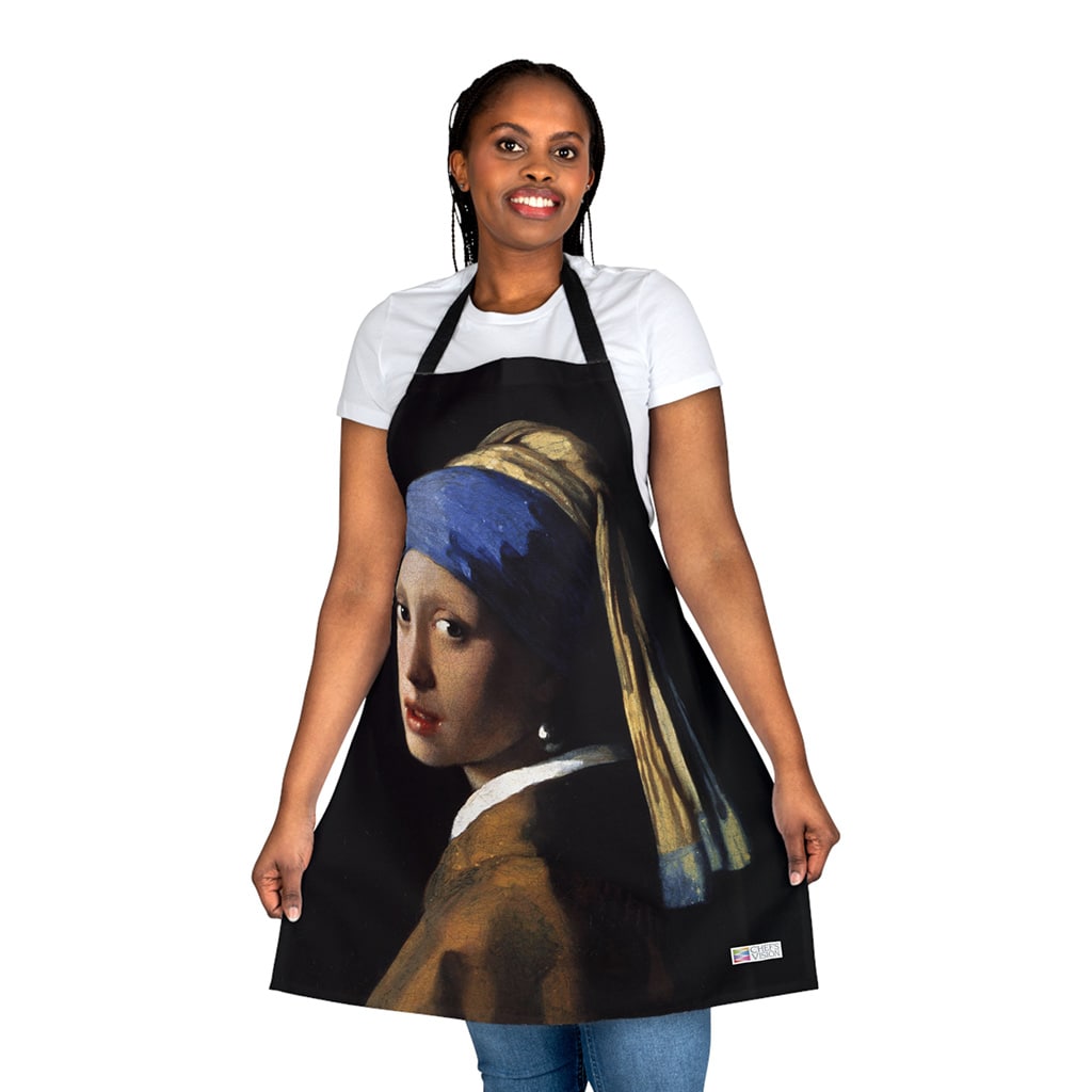 A woman wearing a Chef's Vision Masterpiece Apron with a girl with a pearl earring.