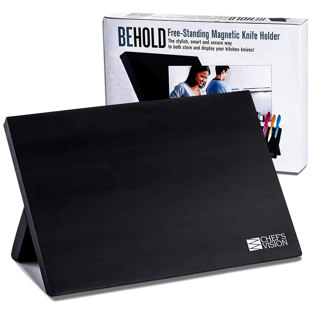 The Chef's Vision BEHOLD Magnetic Kitchen Knife Block in black is shown free-standing before its box, which displays product details and a photo of the holder—ideal for stylish knife storage and kitchen organization.