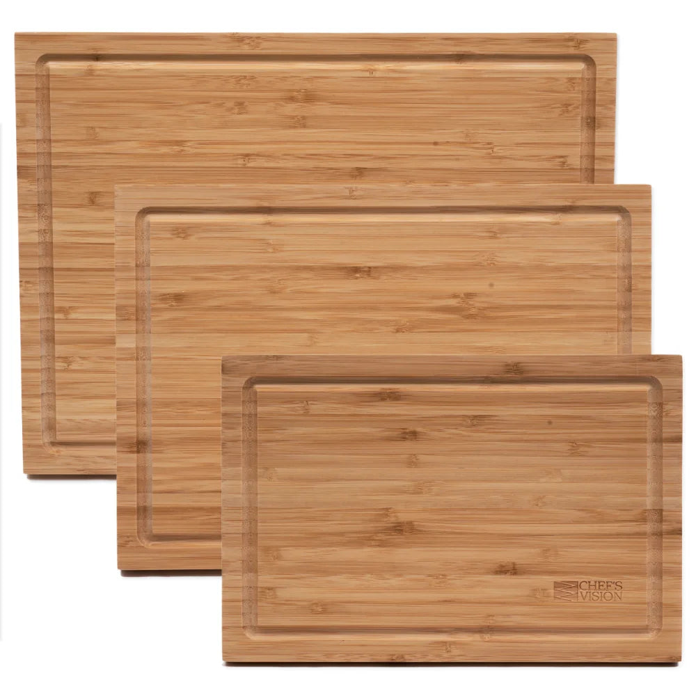 Three rectangular boards from the Chef's Vision Slice Bright Bamboo Cutting Boards - Set of 3, each in a distinct size and designed with deep juice grooves around the edge, are stacked with partial overlap on a plain white background. Their knife-friendly surfaces make them ideal for everyday kitchen use.