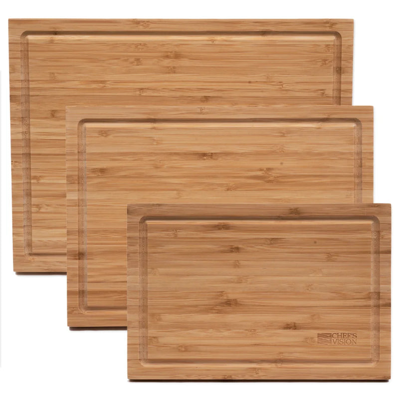 Three rectangular cutting boards from the Chef's Vision SliceBright Moso Bamboo Cutting Boards Set of 3 are arranged with overlapping edges. Each knife-friendly board features a smooth surface and a grooved border designed for collecting juices.
