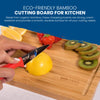 A person expertly slices a lemon on the naturally anti-microbial Slice Bright Bamboo Cutting Board from Chef's Vision, surrounded by vibrant kiwi slices and juicy strawberries. Text overlay accentuates this eco-friendly kitchen companion as an essential tool.