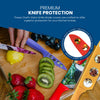 A vibrant Wildlife Series Knife Set by Chef's Vision, featuring colorful knives with BladeKeepers blade covers for premium protection, is displayed beside sliced fruits. These knives are also conveniently dishwasher safe for easy cleaning.