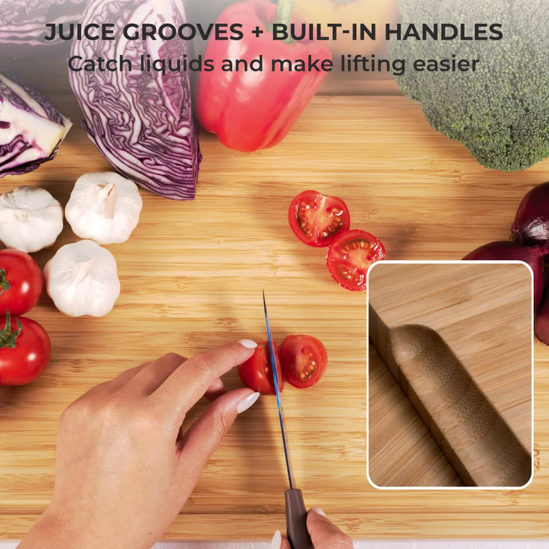 A hand slices a cherry tomato on a Chef's Vision SliceBright Moso Bamboo Cutting Board, part of the set of 3, featuring juice grooves and surrounded by vegetables. An inset highlights the board's built-in handle and knife-friendly surface.