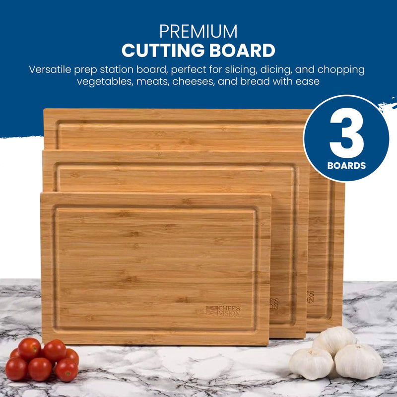 The Chef's Vision Slice Bright Bamboo Cutting Boards - Set of 3, featuring various sizes, are showcased on a marble surface alongside tomatoes and garlic.