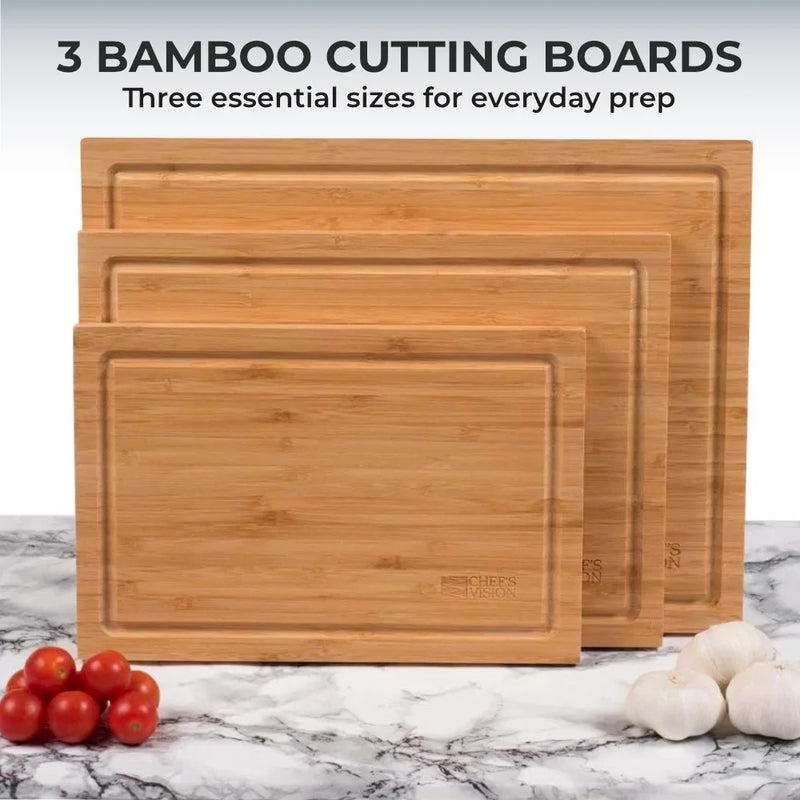 The Chef's Vision Slice Bright Bamboo Cutting Boards Set of 3 features organic bamboo boards of different sizes, each with a grooved edge, stacked upright in a staggered display.
