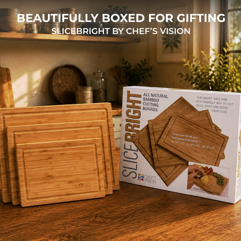 Set of three SliceBright Moso Bamboo Cutting Boards by Chef's Vision, featuring knife-friendly surfaces and deep juice grooves, displayed beside Chef's Vision packaging on a kitchen countertop bathed in sunlight from a nearby window.