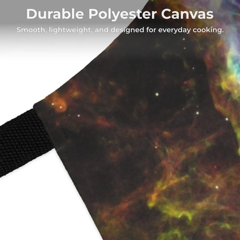 Close-up of the Chef's Vision Cosmos Apron, crafted from durable polyester canvas with space-themed art and a black strap. Overlaid text notes its smooth, lightweight feel—ideal for everyday cooking.
