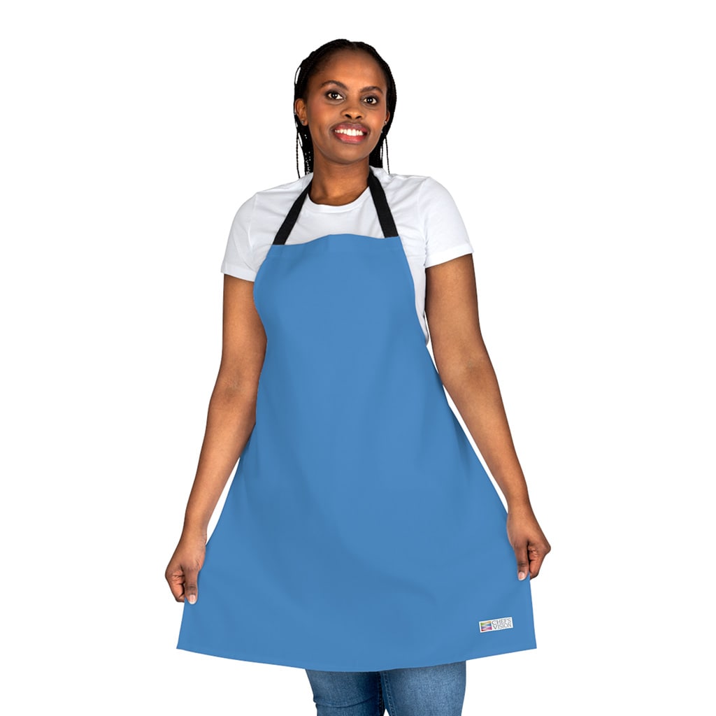 A woman wearing a vibrant blue Color Apron from Chef's Vision's color-themed collection.