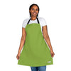 A woman showcasing a vibrant lime green Chef's Vision Color Apron from her color-themed apron collection.