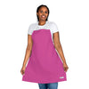 A vibrant woman showcasing a pink apron from her Chef's Vision Color Apron collection.