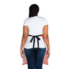 The vibrant back view of a woman wearing a red and black apron from the Chef's Vision Color Apron collection.
