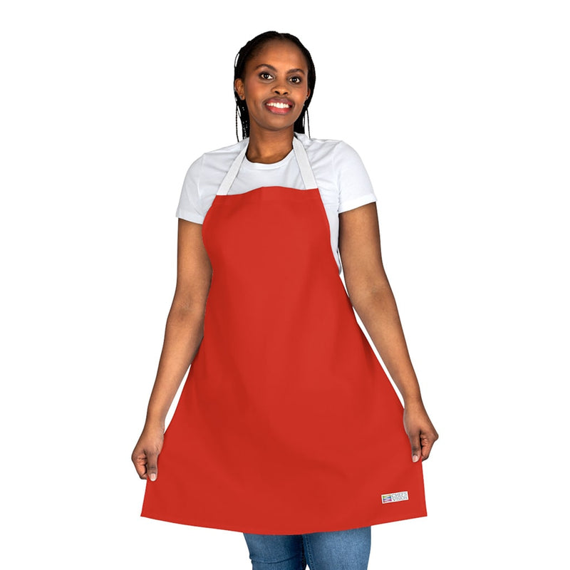 A woman wearing a Chef's Vision red apron.