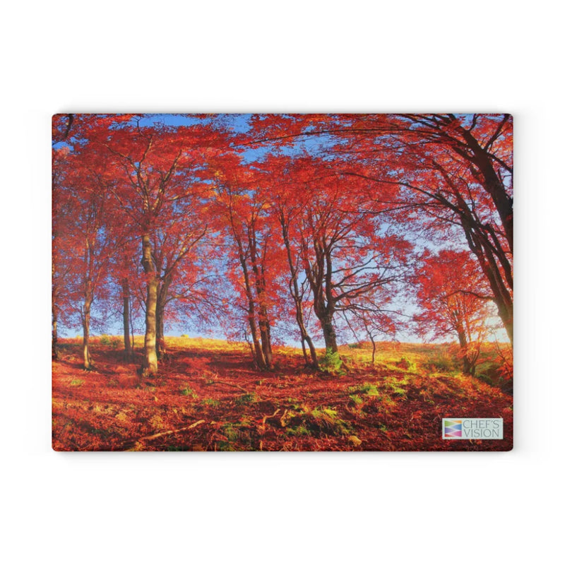 SliceBright Landscape Glass Cutting Board by Chef's Vision features a forest of tall trees with vibrant red autumn leaves and sunlight streaming under a blue sky, bringing beautiful scenery to your kitchen counter.