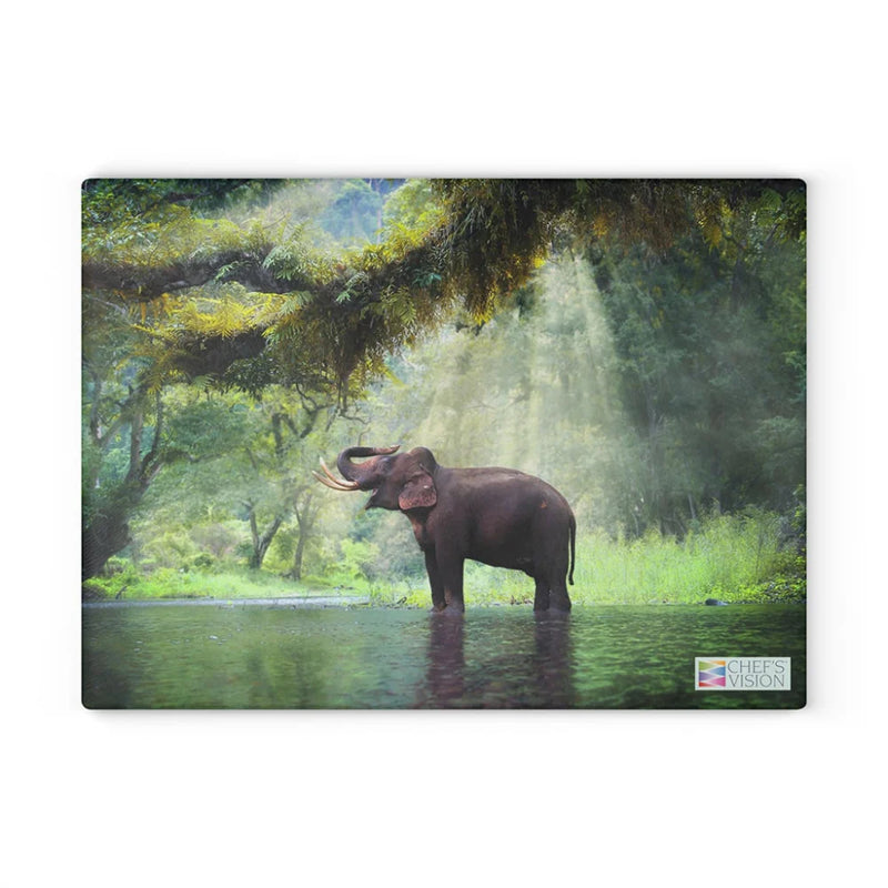 Chef's Vision SliceBright Wildlife Glass Cutting Board features stunning wildlife art of an elephant in a green forest pond with sunlight streaming through trees—perfect for adding beauty to your kitchen.