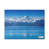 Chef's Vision SliceBright Glass Cutting Board featuring New Zealand's Mount Cook on a blue background.