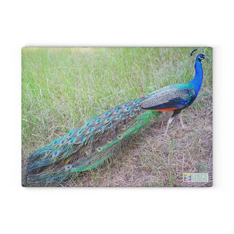 A vibrant peacock with its tail extended in tall grass is beautifully depicted on the SliceBright Wildlife Glass Cutting Board by Chef's Vision, blending functional art and natural beauty for your kitchen.