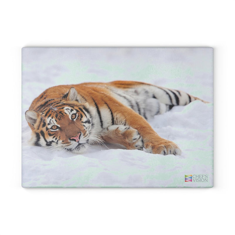 A SliceBright Wildlife Glass Cutting Board, branded by Chef's Vision, depicts a tiger lounging amidst the snowy landscape.