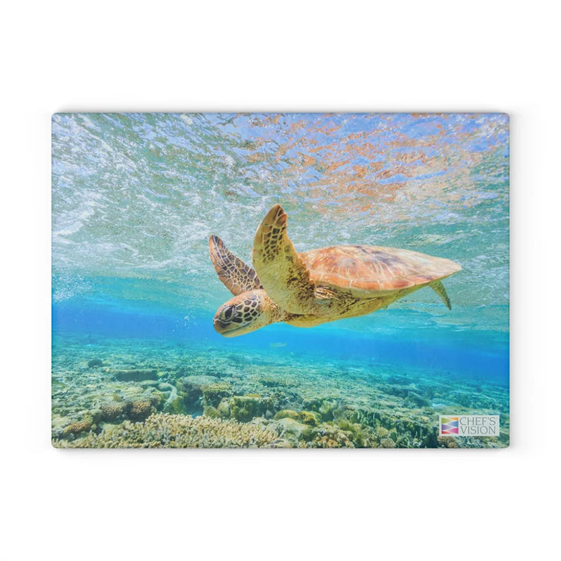 A sea turtle swims above a coral reef in clear blue water, beautifully featured as wildlife artwork on the Chef's Vision SliceBright Wildlife Glass Cutting Board.