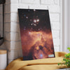 A SliceBright Cosmos Glass Cutting Board by Chef's Vision featuring a image of the eagle nebula hanging on a wall.