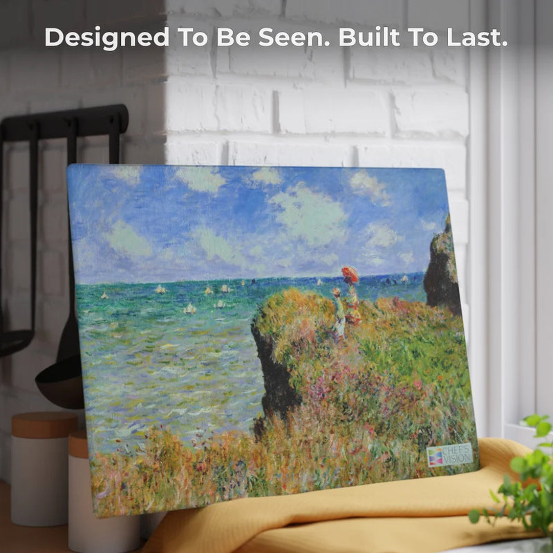 The Chef's Vision SliceBright Masterpiece Glass Cutting Board, featuring an impressionist seaside cliff scene, adds functional art to your kitchen decor. Text above reads, "Designed To Be Seen. Built To Last.