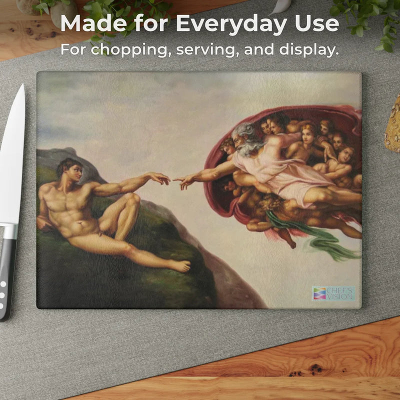 The SliceBright Masterpiece Glass Cutting Board by Chef's Vision, featuring Michelangelo’s "The Creation of Adam," combines artistry and function—a striking piece for chopping, serving, or displaying on your kitchen counter.