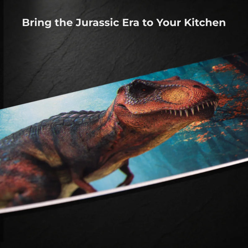 Close-up of a Chef’s Vision Jurassic Six-Piece Knife Set with ergonomic handles, shown on a dark background. Above a realistic T-rex print, the text reads: "Bring the Jurassic Era to Your Kitchen.