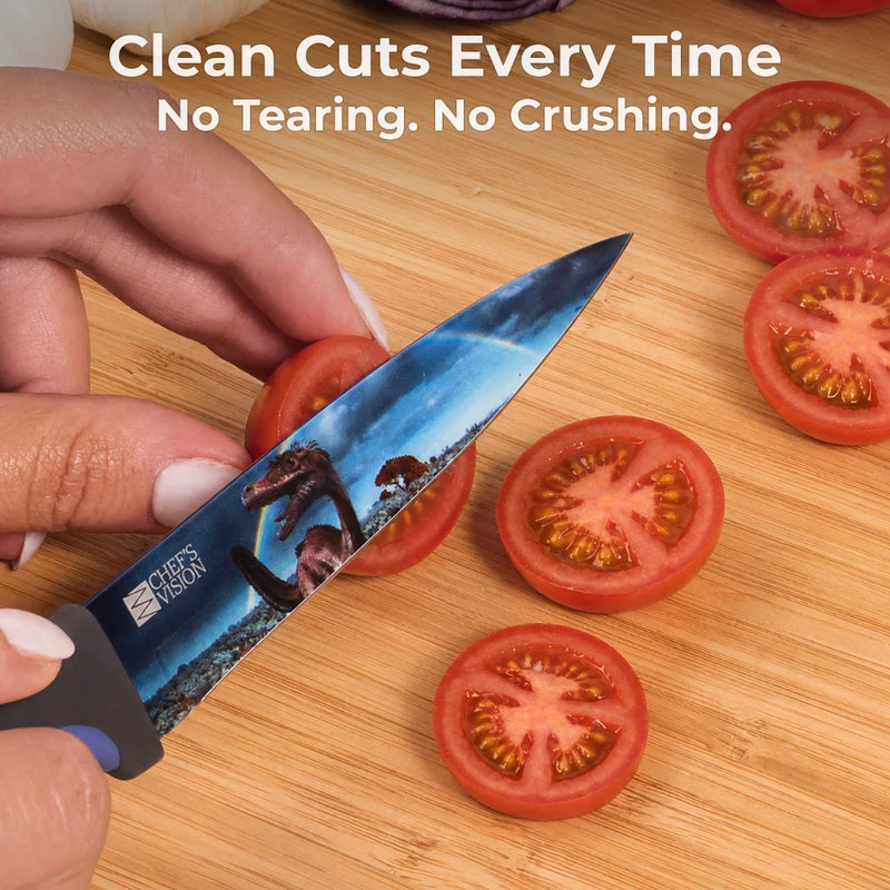 A hand slices cherry tomatoes with a Chef’s Vision Jurassic Six-Piece Knife, featuring ergonomic handles and a vivid dinosaur design. Text: “Clean Cuts Every Time. No Tearing. No Crushing.”.