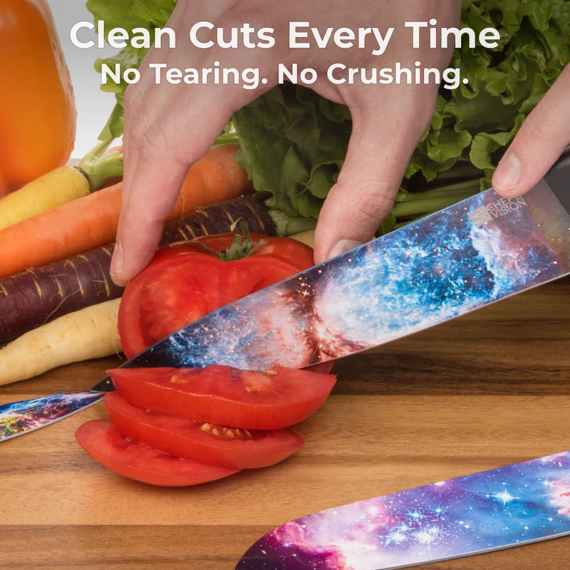 A hand slices a tomato with a Cosmos Six-Piece Knife from Chef's Vision, featuring vibrant galaxy designs. Surrounded by fresh veggies on wood. Text: "Clean Cuts Every Time. No Tearing. No Crushing.