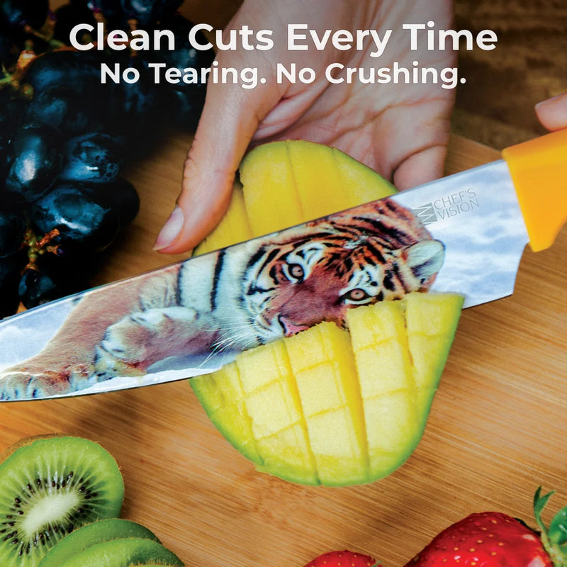 A hand slices mango with a Chef's Vision Wildlife Six-Piece Knife, featuring a tiger image. Kiwi and grapes bring color. Text: “Clean Cuts Every Time. No Tearing. No Crushing.” Enjoy ergonomic handles and non-stick coating for precision cutting.