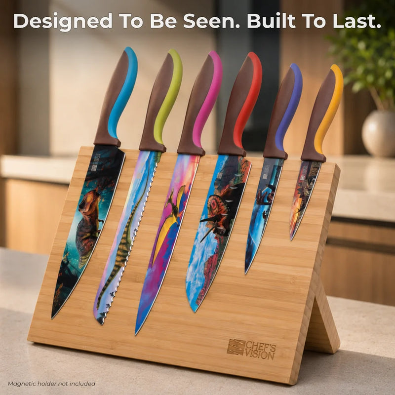 The Chef's Vision Jurassic Six-Piece Knife Set features artistic, colorful stainless steel blades and ergonomic handles, displayed on a wooden magnetic knife holder on your kitchen counter.