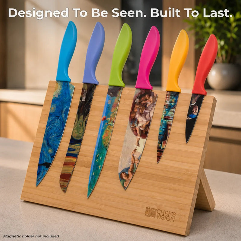 The Chef’s Vision Masterpiece Six-Piece Knife Set features stainless steel blades with artistic designs and colorful, ergonomic handles, displayed on a wooden magnetic holder. Text reads: "Designed To Be Seen. Built To Last.