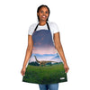 A woman wearing a Chef's Vision Jurassic Apron with an image of a dinosaur in the field, offering a unique gift for dinosaur enthusiasts.