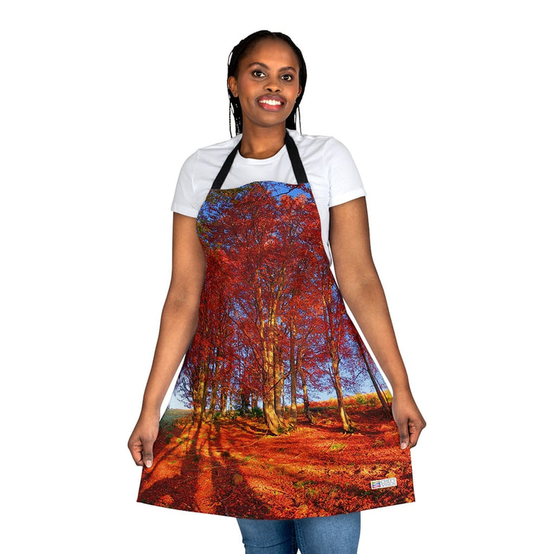 A woman wearing a red Chef's Vision apron with a tree in the background.