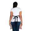 The back view of a woman wearing a Chef's Vision Landscape Apron, showcasing the beauty of nature.