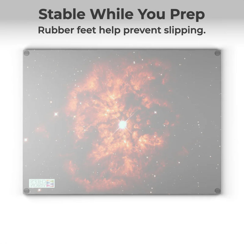 The Chef’s Vision SliceBright Cosmos Glass Cutting Board features cosmic imagery and rubber corner feet for stability, keeping your board secure while you prep.