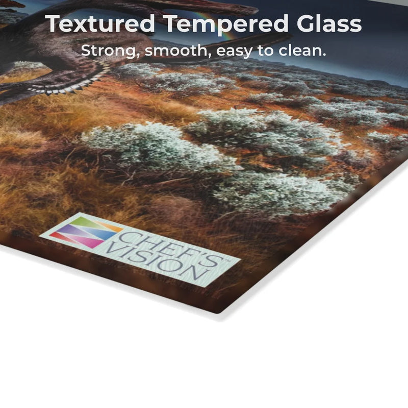 Close-up of the SliceBright Jurassic Glass Cutting Board by Chef's Vision, featuring textured tempered glass with landscape, animal, and dinosaur art. Strong, smooth, and easy to clean—perfect for your kitchen counter.