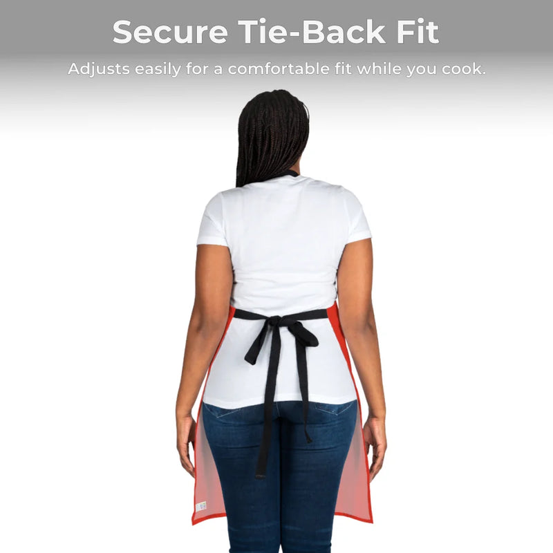 A person models the Chef's Vision Color Apron—red with a black adjustable tie-back—over a white shirt and blue jeans. The apron’s fit is highlighted as ideal for chefs, making it a perfect gift.
