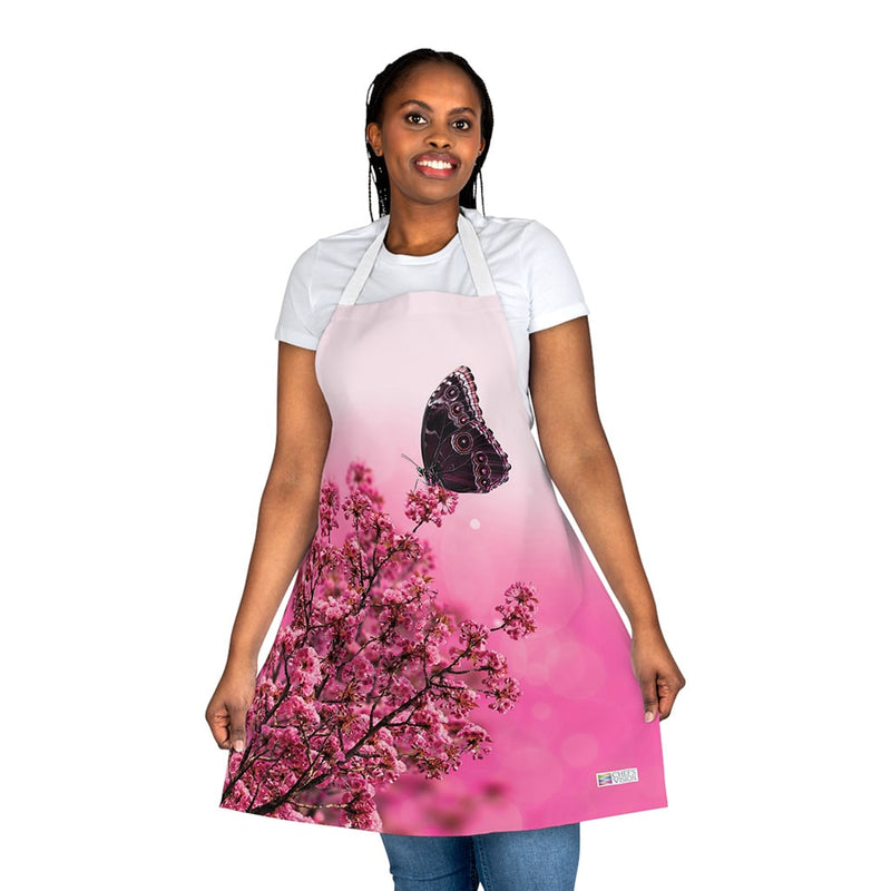 A woman wearing a Chef's Vision Wildlife Apron with a butterfly on it.