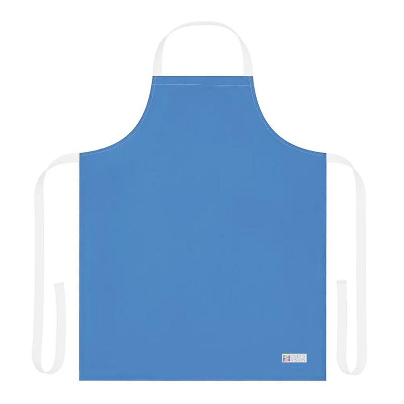 The Chef's Vision Color Apron in plain blue features black neck and waist straps, a small white label at the bottom right, and is displayed on a white background—making it a stylish choice for kitchens or as a thoughtful chef gift.