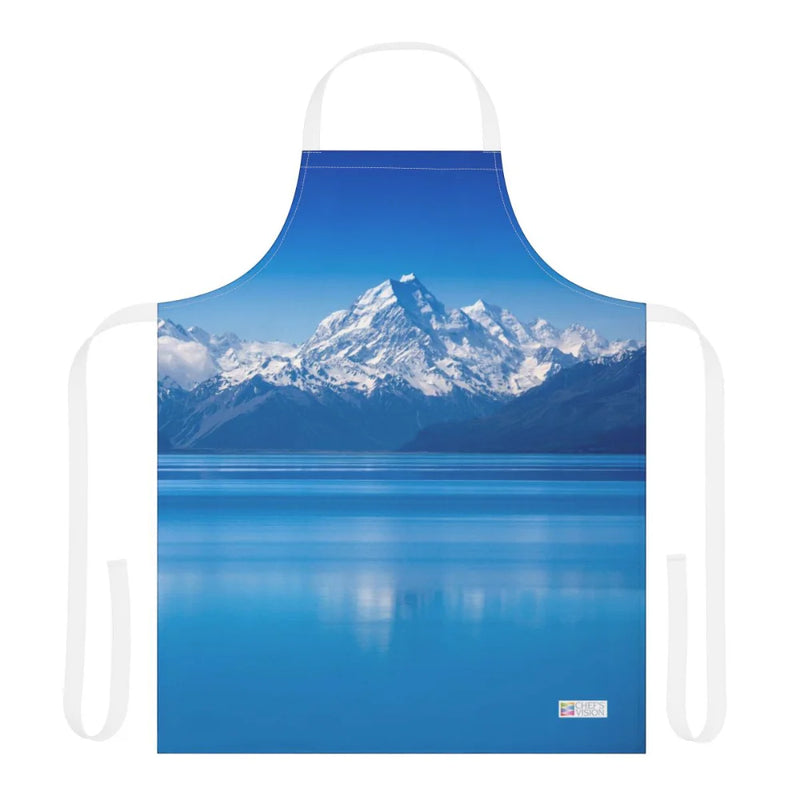 The Chef's Vision Landscape Apron showcases snow-covered mountains mirrored in a blue lake on durable polyester canvas—ideal for fans of nature-inspired artwork and scenic aprons.