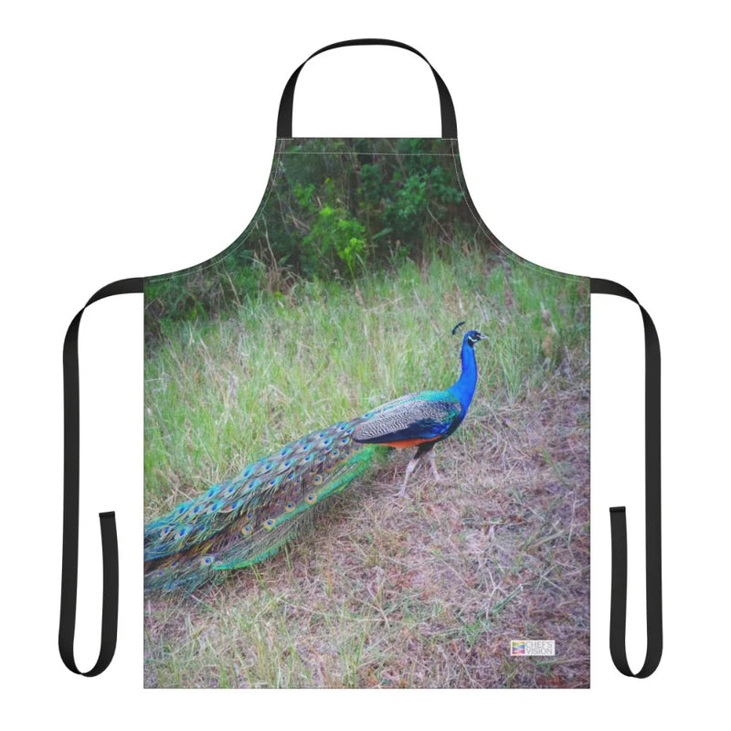 The Chef's Vision Wildlife Apron showcases a vibrant peacock with colorful plumage standing on grass near greenery, expertly crafted from durable polyester canvas.