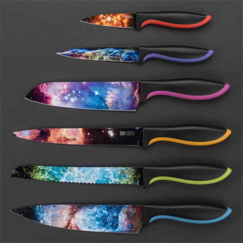The Chef's Vision Cosmos Six-Piece Knife Set features vibrant galaxy-themed blades and multicolored handles, beautifully arranged on a dark background to highlight this stunning stainless steel knife collection.